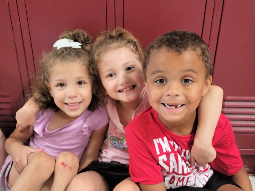 Children in Clinton Jumpstart program smiling in front of lockers