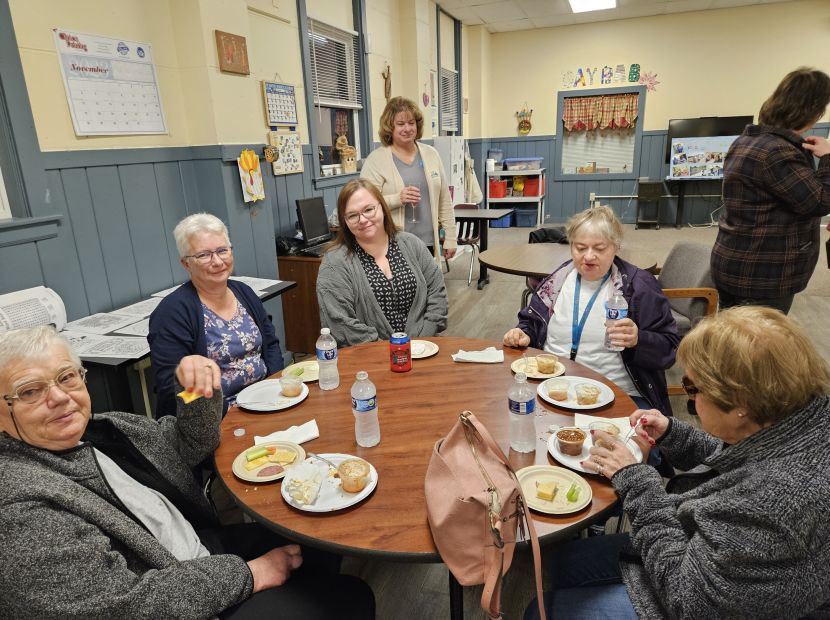 Group of women sitting at a table for Clinton, IA non-profit called Skyline